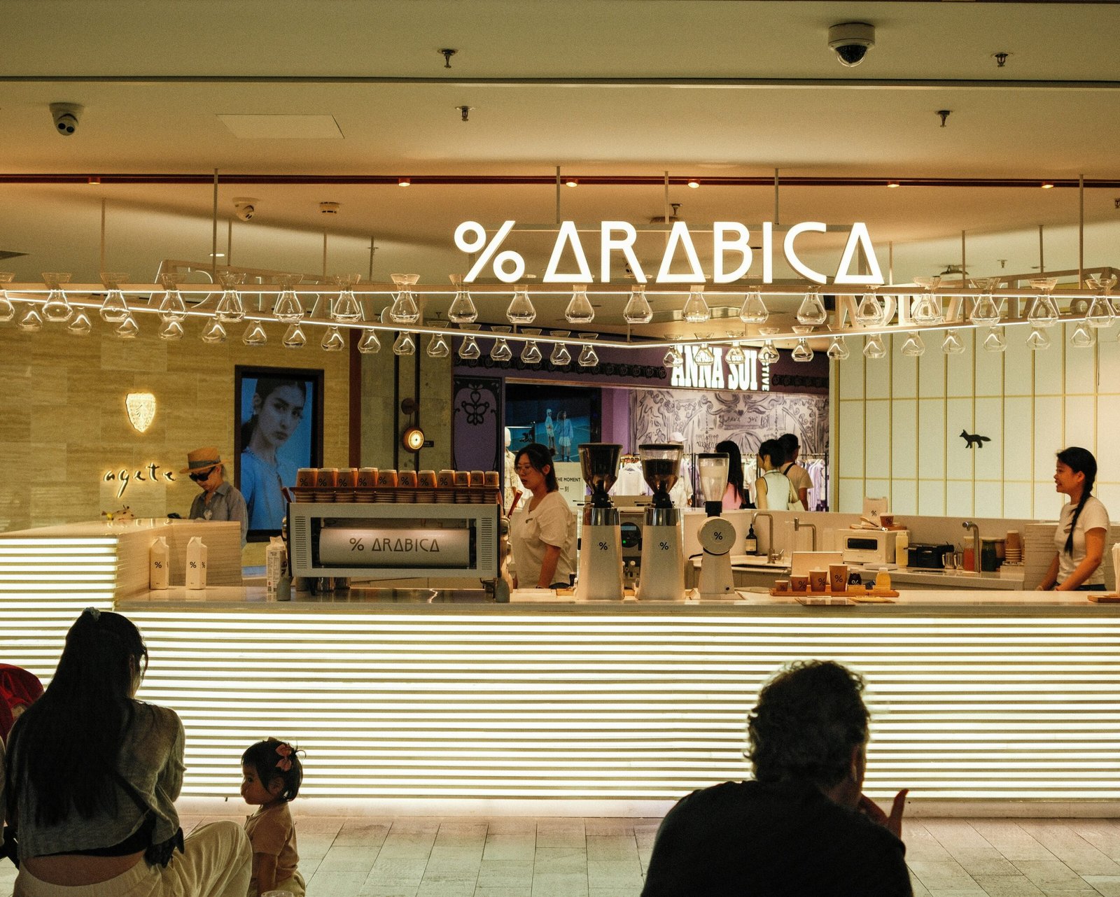 A group of people sitting in front of a store